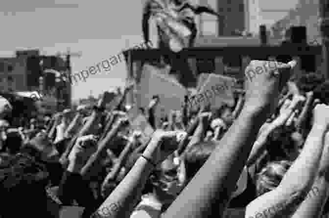 A Powerful Black And White Photograph Of Protesters Raising Their Fists In Solidarity. PRIDE: Fifty Years Of Parades And Protests From The Photo Archives Of The New York Times